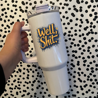 well shit design in yellow and blue on a 40oz tumbler with a handle