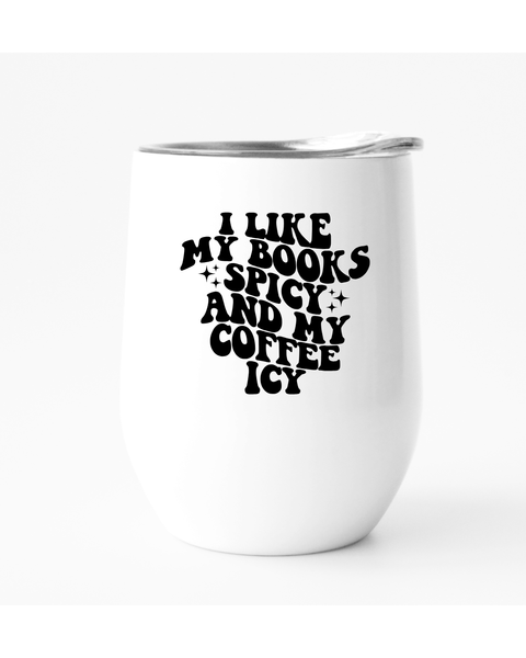 White tumbler with black text 'I LIKE MY BOOKS SPICY AND MY COFFEE ICY' on a white background